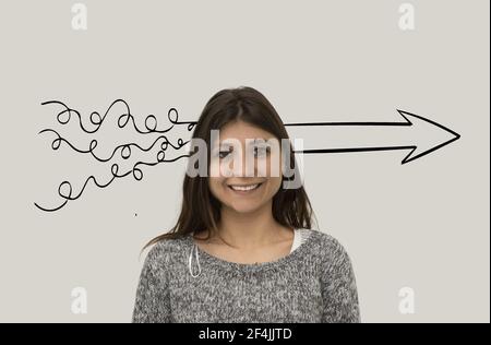 Smiling woman is thinking about process of problem solving. Scribbles turn into an arrow. Problem solving concept. Stock Photo