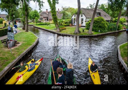 Giethoorn, Netherlands - July 6, 2019: Tourists sailing on boats in the canals of the village of Giethoorn, the Netherlands Stock Photo