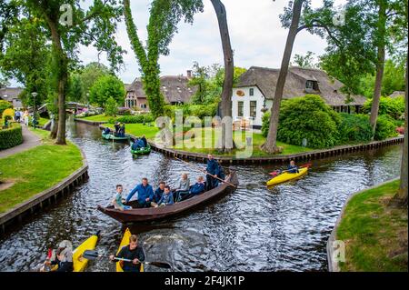 Giethoorn, Netherlands - July 6, 2019: Tourist groups on boats traveling through the canals of the village of Giethoorn in the Netherlands Stock Photo