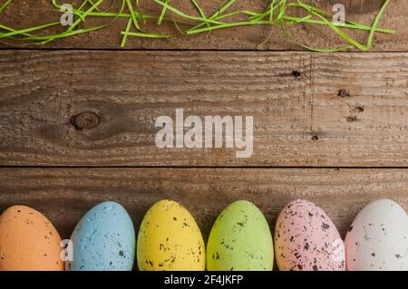Simple easter background: colored easter eggs on a wooden table Stock Photo