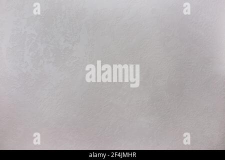 Texture of a grey stone decorative plaster or concrete wall. Abstract background for design. Gray decorative plaster inside the house. Stock Photo