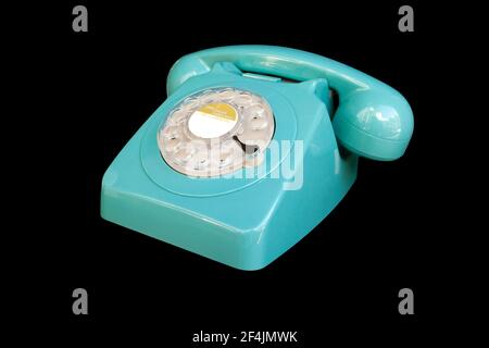 Turquoise rotary dial seventies telephone. Isolated over black Stock Photo