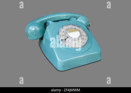 Turquoise rotary dial seventies telephone. Isolated over grey Stock Photo