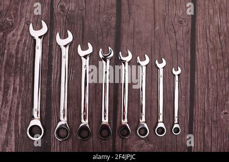 a set of spanners on a wooden background.  Stock Photo