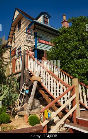 Teenage girl standing at the top of the stairs leading to the post office in Sweethaven, Popeye Village, the set for the movie Popeye in Malta. Stock Photo