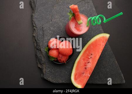 Watermelon smoothies or juice topping with fresh watermelon and mint leaves for summer drinks concept. Stock Photo