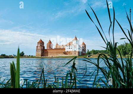 Mir castle complex in summer day with blue cloudy sky. Tourism landmark in Belarus, cultural monument, old fortress Stock Photo