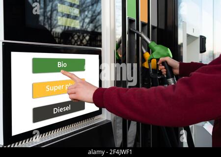 A man chooses biofuel at a self-service gas station Stock Photo
