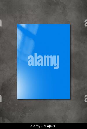 Blue booklet cover isolated on dark concrete background, mockup template Stock Photo