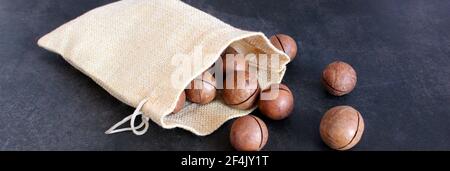 Organic Macadamia nut on dark table Stock Photo