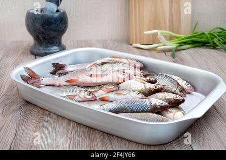 Fresh catch of river fish in a bowl on the table. Healthy food concept. Proper nutrition. Stock Photo