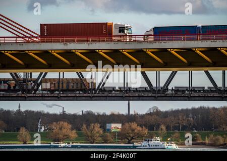 Beeckerwerther bridge, motorway bridge, A42, truck, goods train on the Haus-Knipp railway bridge, freight ship on the Rhine, in Duisburg, NRW, Germany Stock Photo