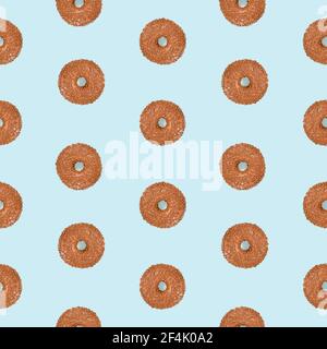 Seamless pattern with donuts glazed with chocolate with brown sprinkles on light blue background Stock Photo