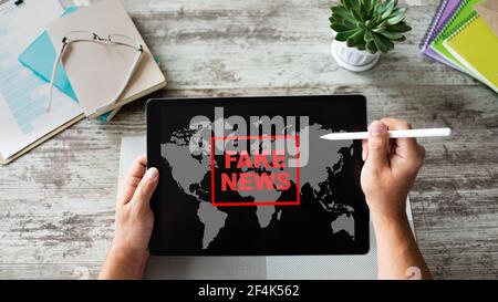 Fake news sign on screen. Propaganda and disinformation. Media and internet concept. Stock Photo