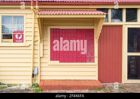 Bright red coloured post boxes outside the Central Tilba Post Office on the New South Wales south coast in Australia Stock Photo