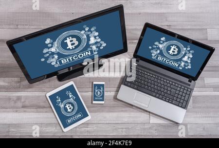 Bitcoin concept shown on different information technology devices Stock Photo