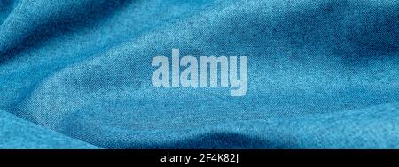 Banner background of blue cotton cloth with pleats. Crumpled azure fabric texture, wavy pattern of wrinkled fabric. Rough natural linen fabric Stock Photo