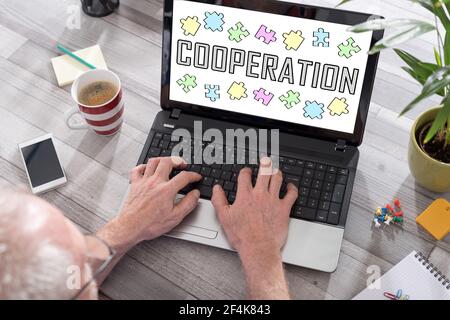 Cooperation concept shown on a laptop used by a man Stock Photo