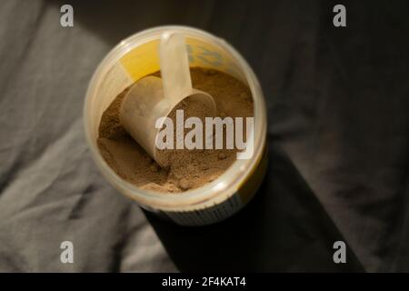 a scoop of chocolate whey protein Stock Photo