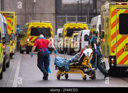 IMAGE PIXELLATED BY PA PICTURE DESK File photo dated 13/01/21 of paramedics unloading a patient from an ambulance outside the Royal London Hospital in London. .Tuesday marks the first anniversary of the announcement on March 23, 2020 of the first UK-wide lockdown. Issue date: Monday March 22, 2021.