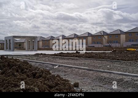 GREYSTONES, IRELAND - Mar 16, 2020: Construction site with row of newly built identical detached houses. It's the part of the Glenveagh Marina Village Stock Photo