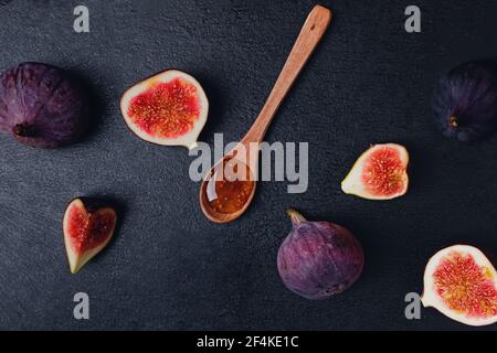 Fig jam and fresh figs on black stone background, Stock Photo