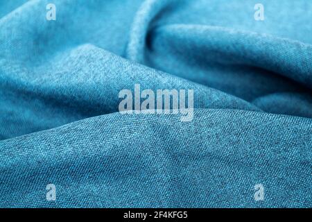 Blue fabric texture close up , focus only one point , soft blurred background wallpaper. Rough fabric texture, textile industry background with blurred. Colored cotton cloth. Abstract background Stock Photo