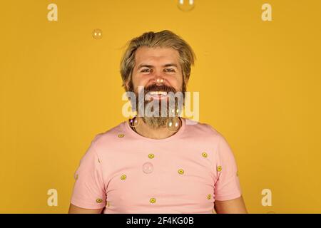 having fun. Fall into childhood. feeling childish and childlike. real happiness. mature man blowing soap bubbles. stay carefree at any age. man with Stock Photo