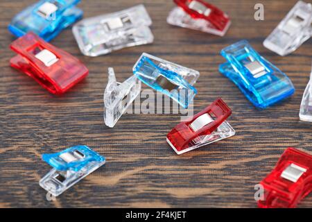 Bright sewing quilting clips on a wooden surface Stock Photo