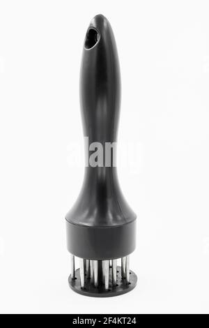 A hand-powered meat tenderizer for puncture the meat and cut into the fibers of the muscle on white background Stock Photo