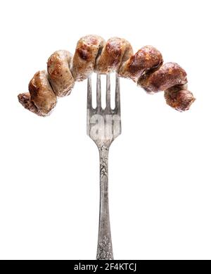 Grilled  spiral sausage on a fork isolated on white Stock Photo