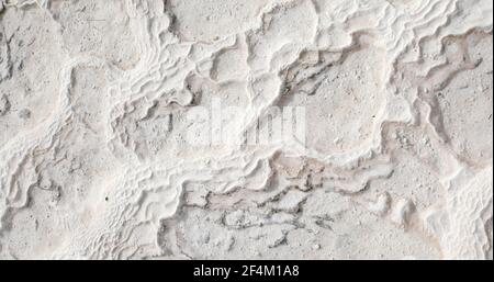 Snow white abstract mineral water blurred calcium formed texture of travertines of Pamukkale cliff surface in Turkey. Stock Photo