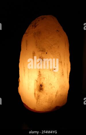 Himalayan salt crystal la,p on a black bckground Stock Photo