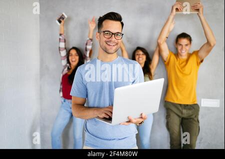 Education, technology and people concept. Happy group of friends using digital devices Stock Photo