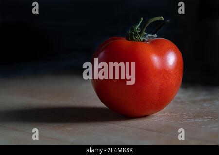 Ripe Tomato on Black Background Stock Photo