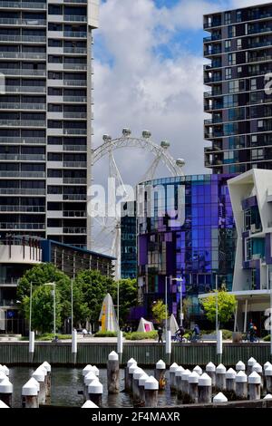 Melbourne, VIC, Australia - November 03, 2017: Victoria Harbor and residential buildings in new Waterfront City in Docklands district with Ferris whee Stock Photo