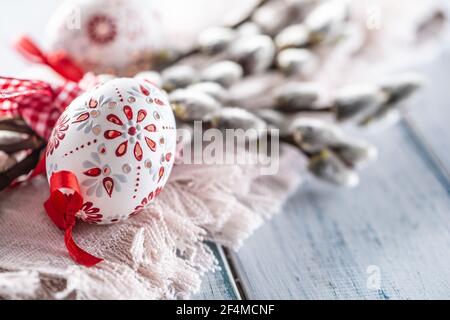 Handmade easter eggs with willow catkins on a linen napkin. Stock Photo