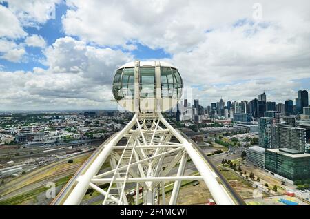 Melbourne, VIC, Australia - November 03, 2017: Gondola of Melbourne Star Observation Wheel with skyline of the capital Stock Photo