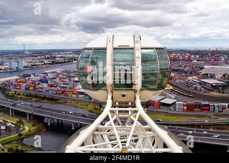 Melbourne, VIC, Australia - November 03, 2017: Gondola of Melbourne Star Observation Wheel with view to harbor and container shipping docks in Docklan Stock Photo