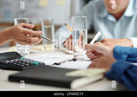 Group of business people working with papers and discussing ideas at weekly meeting in office Stock Photo