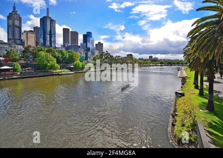 Melbourne, VIC, Australia - November 04, 2017: Buildings and unidentified rowers by training on Yarra river Stock Photo