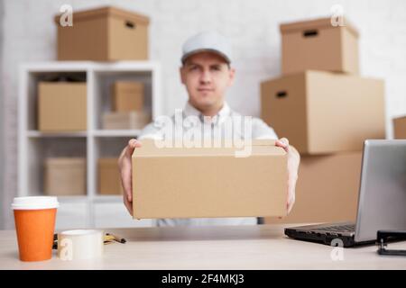 work, shipping and postal delivery concept - close up of parcel in postman hands Stock Photo