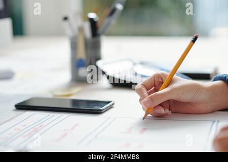 Close-up image of UX designer working on layout of website or mobile application interface Stock Photo