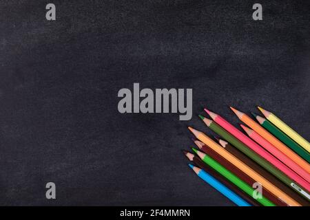 Top view of many different colored pencils on a blackboard background Stock Photo