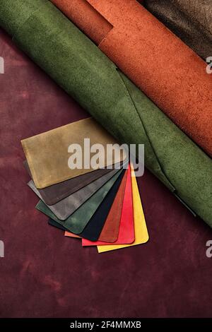 Artificial leather samples on a cow leather background. Top view Stock Photo