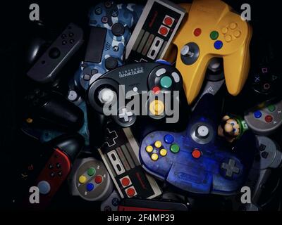 HAMBURG, GERMANY - Dec 11, 2020: Some controllers for game consoles. Old controllers and new controllers. Stock Photo