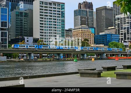 Melbourne, VIC, Australia - November 03, 2017: Metro train and buildings along Yarra river Stock Photo