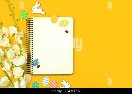 Spring mockup with easter decor on a yellow background, top view and copy space photo Stock Photo