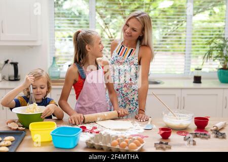 Mom and son in aprons play with flour while cooking at home in the kitchen  against the background of kitchen utensils. Selective focus. Portrait. Clos  Stock Photo - Alamy