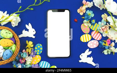 Easter template with blank white screen, modern spring mockup concept with flowers decorations Stock Photo